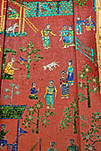 Wat Xieng Thong temple in Luang Prabang, Laos.  La Chapelle Rouge , the Red Chapel. The exterior walls are decorated with colourful mosaics on a pink background with scenes of people daily activities. North wall. 